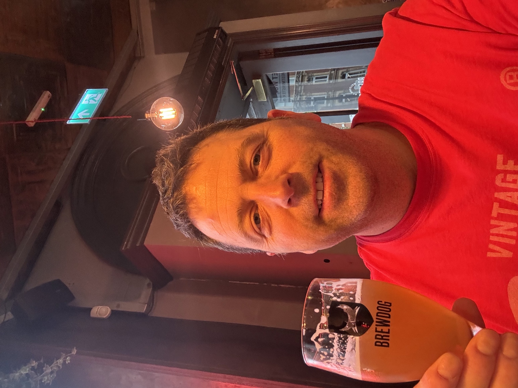 Derek with a beer inside a BrewDog bar