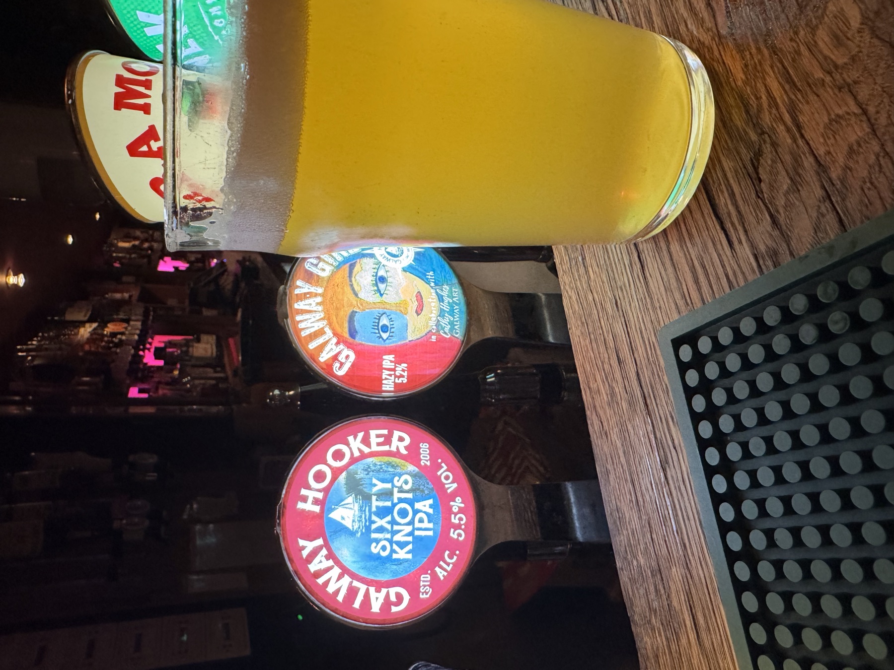 Galway Hooker Sixty Knots and Galway Girl tap badges beside a pint