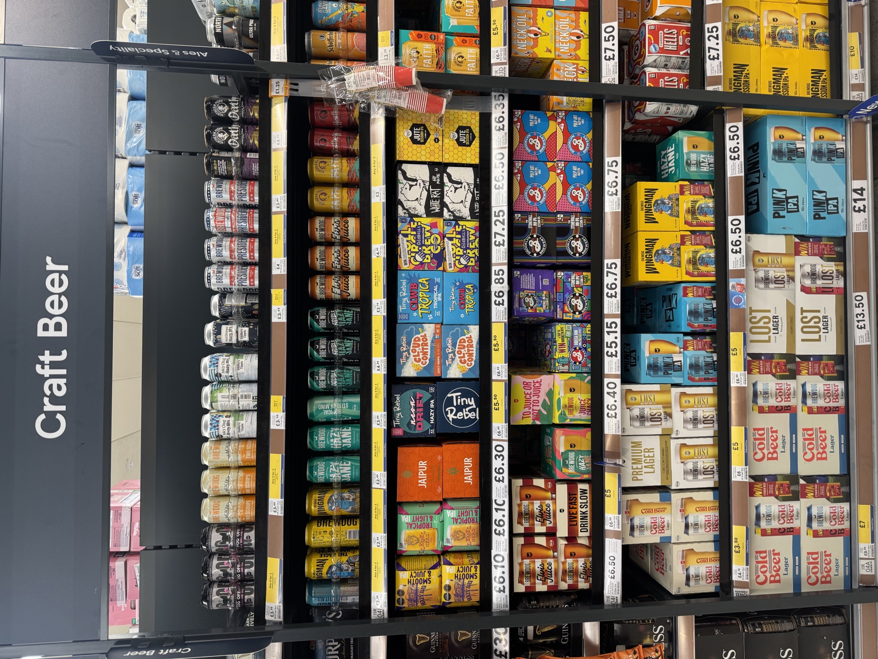 A craft beer bay in a UK supermarket with prices visible