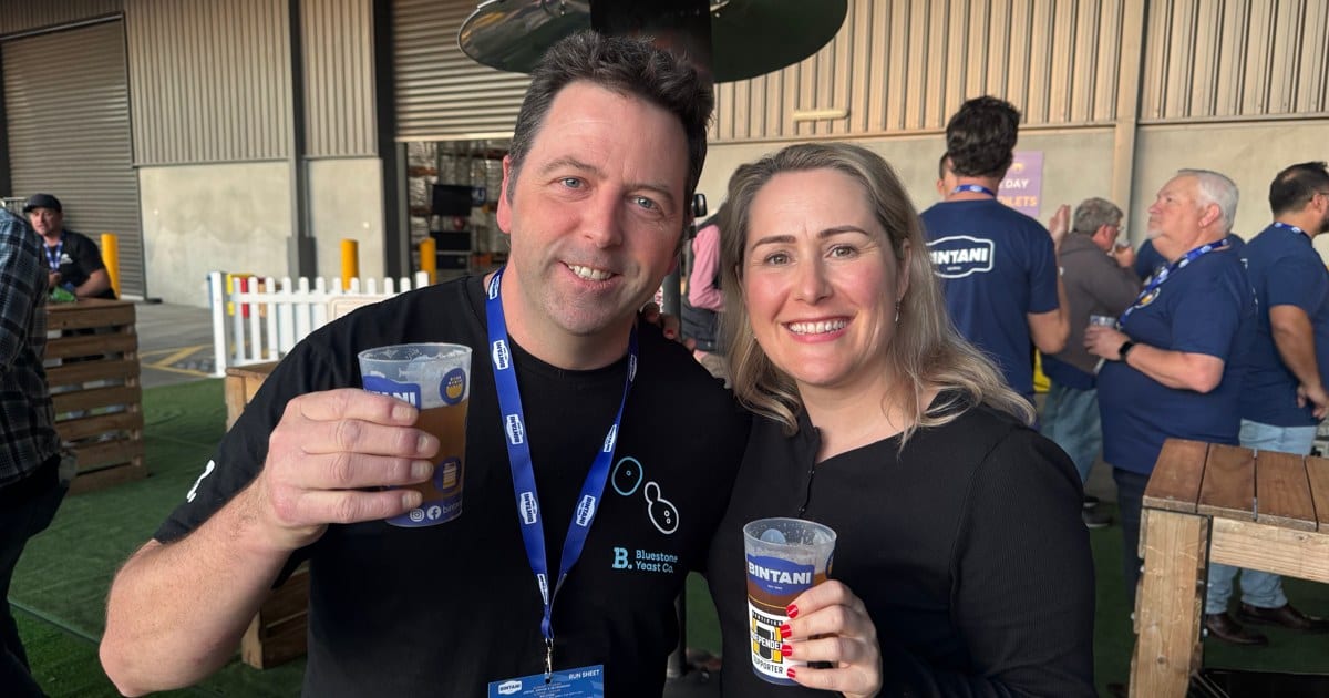 Two people holding drinks at the Bintani Trade Day
