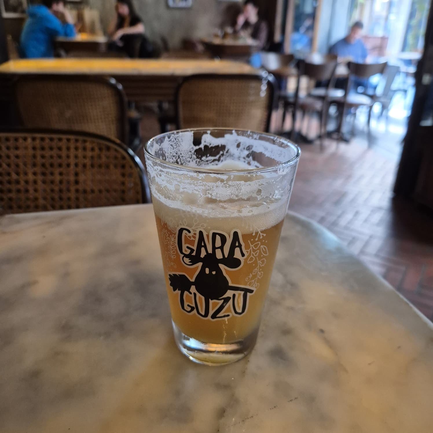 A Gara Guzu beer in a branded glass at an Istanbul craft bar