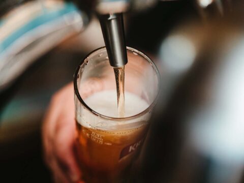 Craft beer being poured into a pint glass